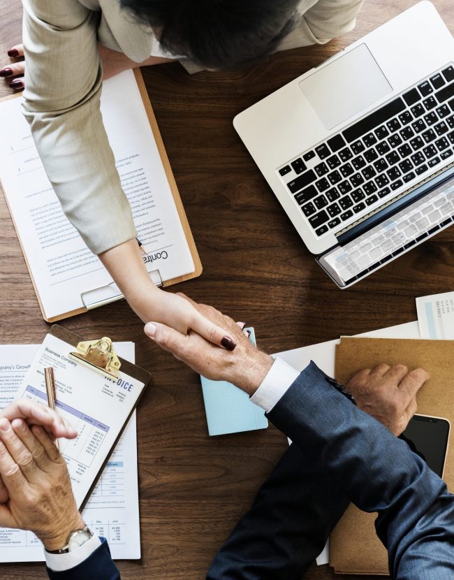 Business people shaking hands together